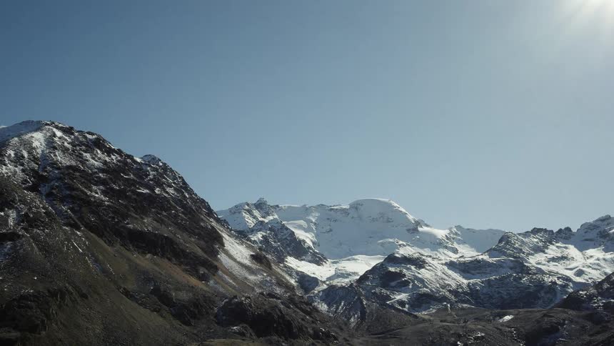 Sunshine over snow capped mountains