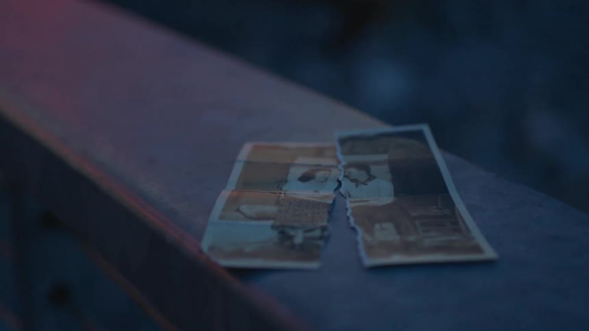 A picture torn in half on a ledge