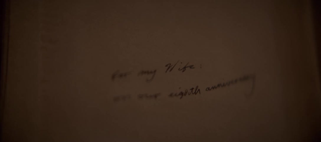 A heartfelt anniversary message, 'For my Wife: on our eighth anniversary,' is revealed in a slow focus pull on a handwritten note