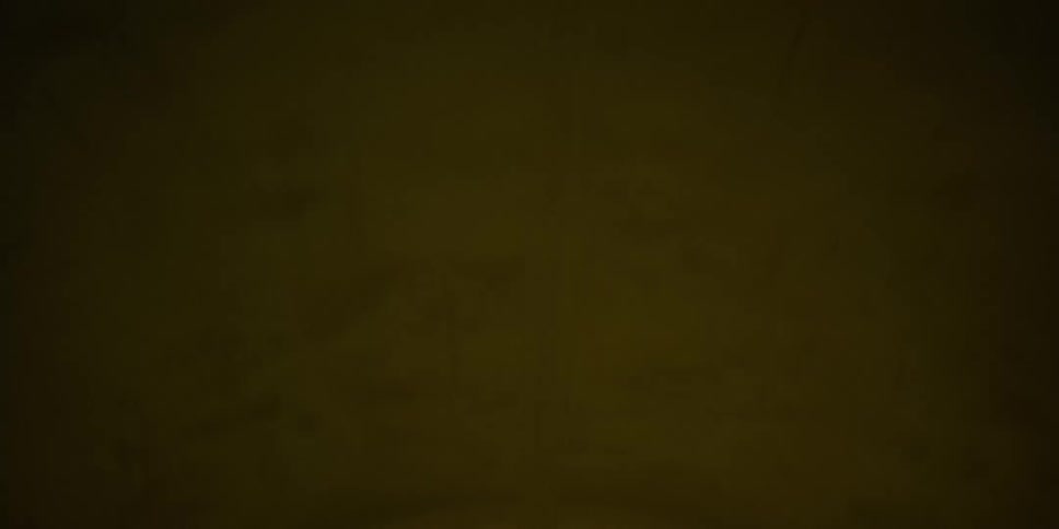 Driving through a dimly lit highway tunnel at night, with yellow ceiling lights passing by in sequence
