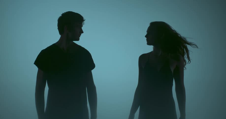 A man and woman are turning toward each other