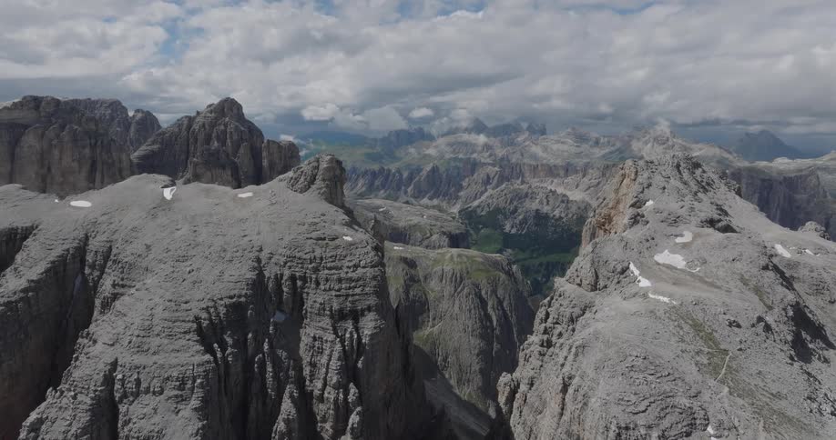 A majestic aerial flight slowly reveals the vast and rugged peaks of the Dolomite mountain range