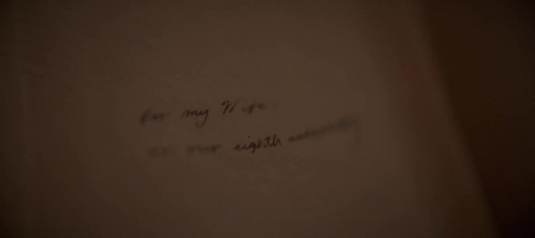 A handwritten anniversary dedication to a wife comes into focus on a piece of paper