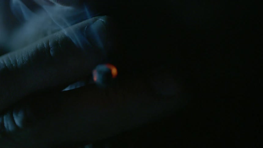 A person smokes a cigarette