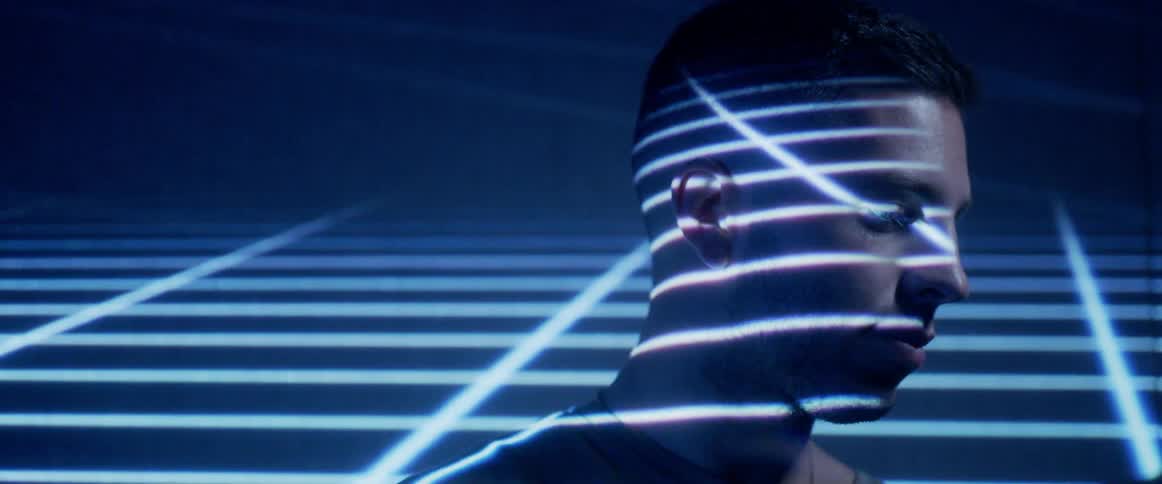 A person standing with a room with blue and white lights on them