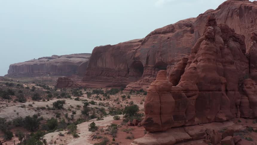 A wide, scenic view of the majestic red sandstone formations and arid landscape of Arches National Park in Utah