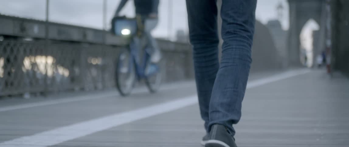 Pedestrians walk and bicycle in a city