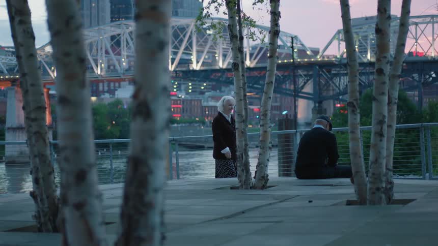 Older woman walks towards an older man