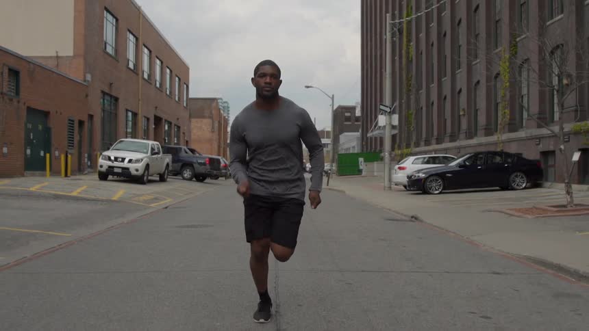 A man is running down the city street