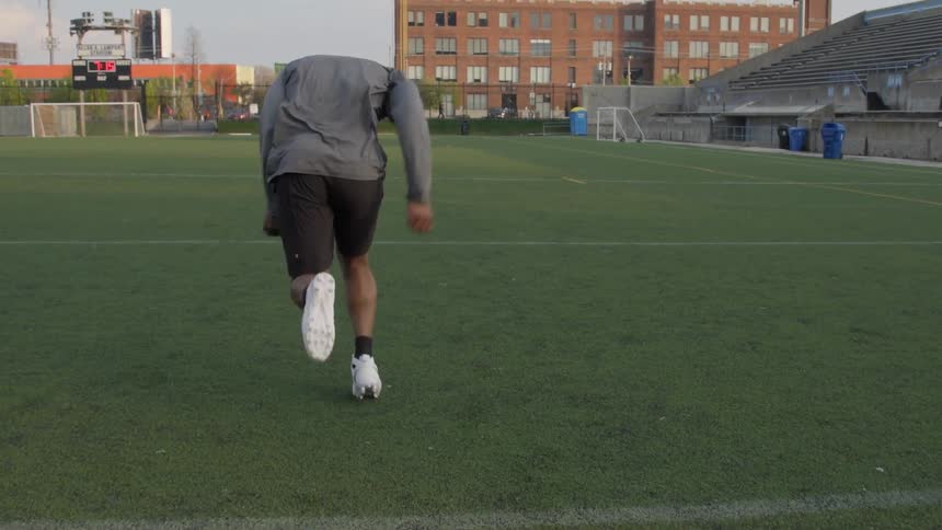 A man preparing to run down a football field