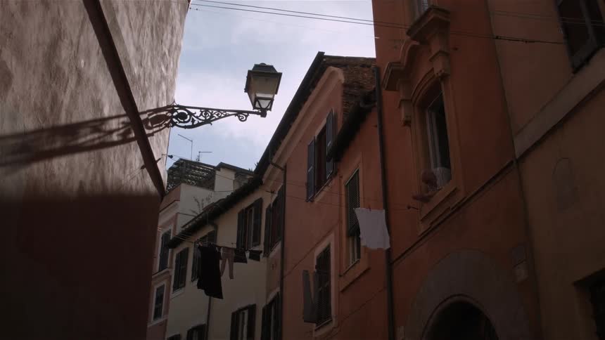 Orange and coral building's line a city street
