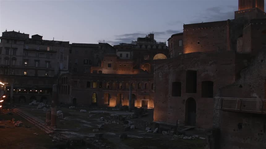 Old city building lit up at dusk