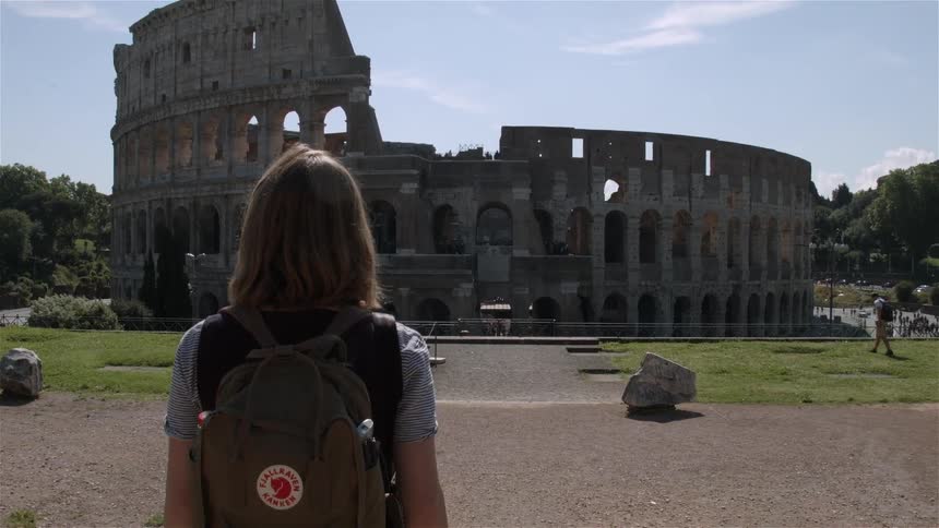 A woman looks towards a monument ahead