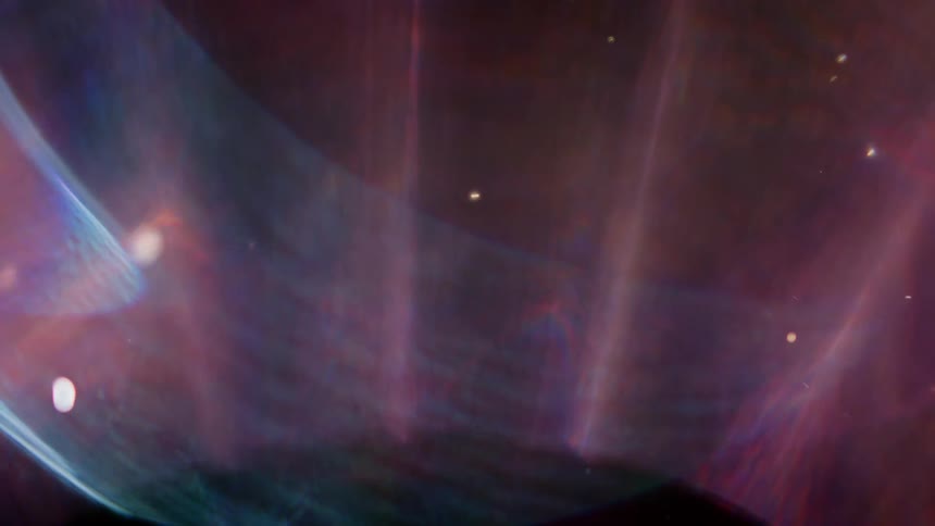 Vibrant particles and orbs float through a colorful, ethereal cosmic nebula