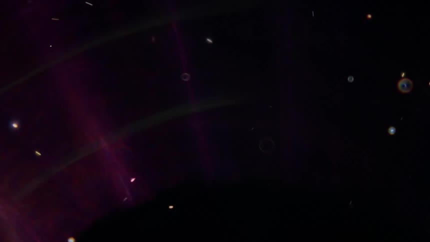 An abstract journey through a colorful cosmos filled with glowing orbs, particles, and ethereal light flares