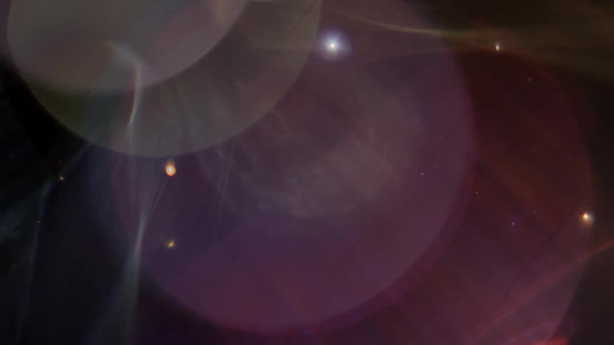 Colorful bokeh lights shift and change as ethereal bubbles and glowing particles float through an abstract space