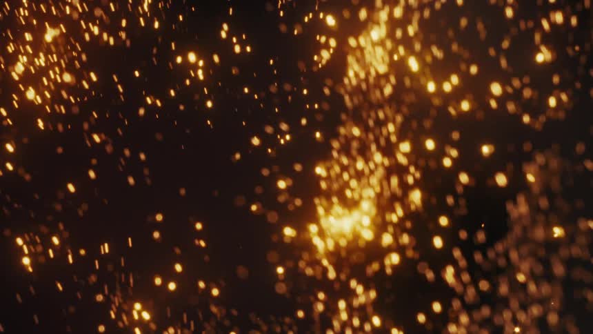 A mesmerizing abstract background of shimmering golden glitter particles floating and swirling in slow motion against a dark backdrop