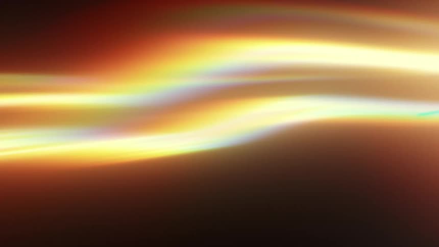 Soft, flowing ribbons of golden light with rainbow accents move gracefully on a dark background