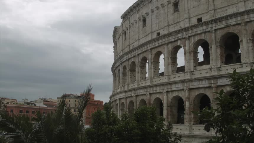 Trees sway in the breeze near an ancient ruin