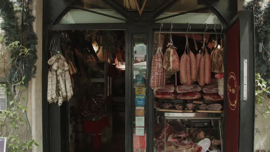 Meats hanging from a local shop window