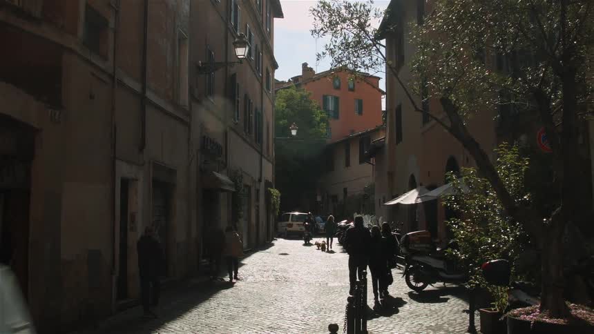 People walk down the street on a windy day