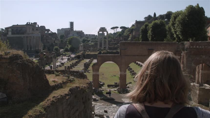 Woman looks out at ruins