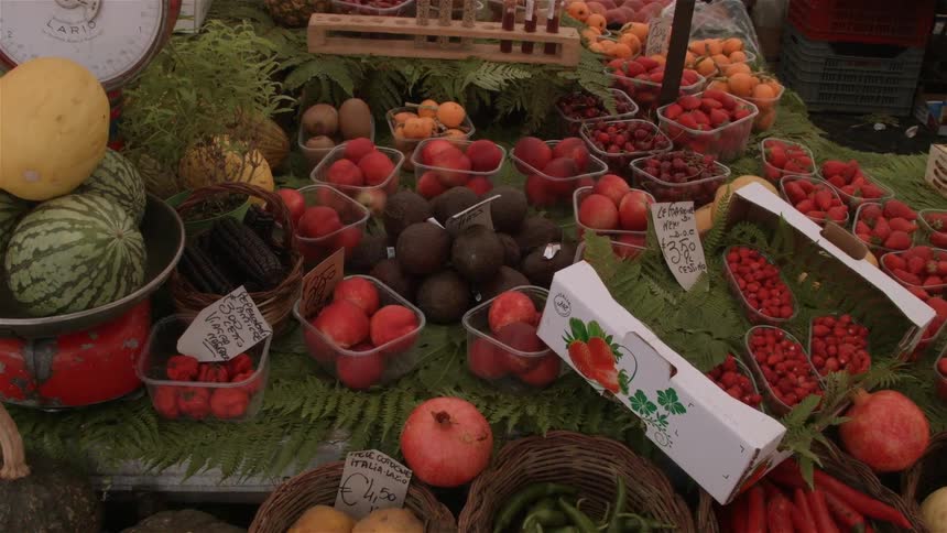 Fruits and vegetables are for sale at an outdoor market