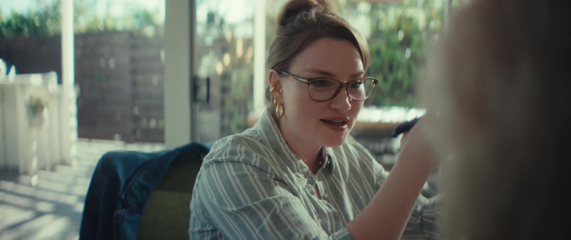 Close-up of a businesswoman wearing glasses talking and explaining a concept during a meeting