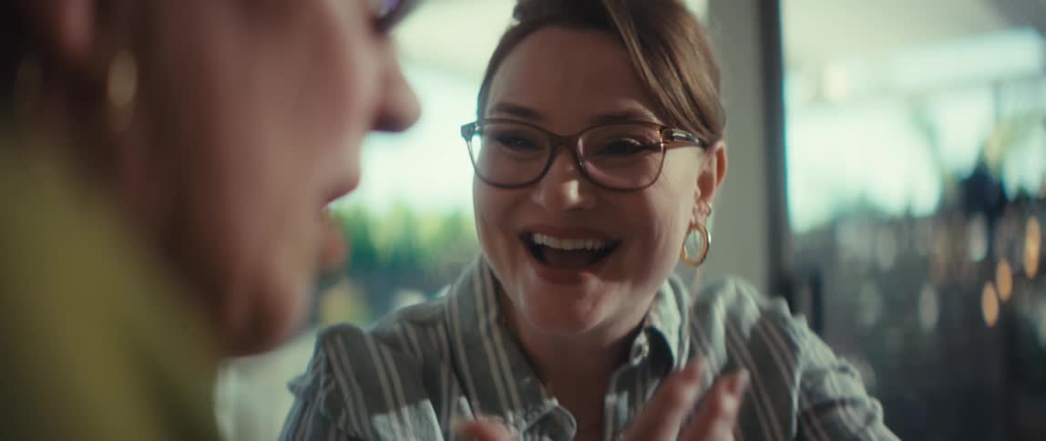 Close up of a young businesswoman smiling and enthusiastically explaining her work on a laptop to a colleague