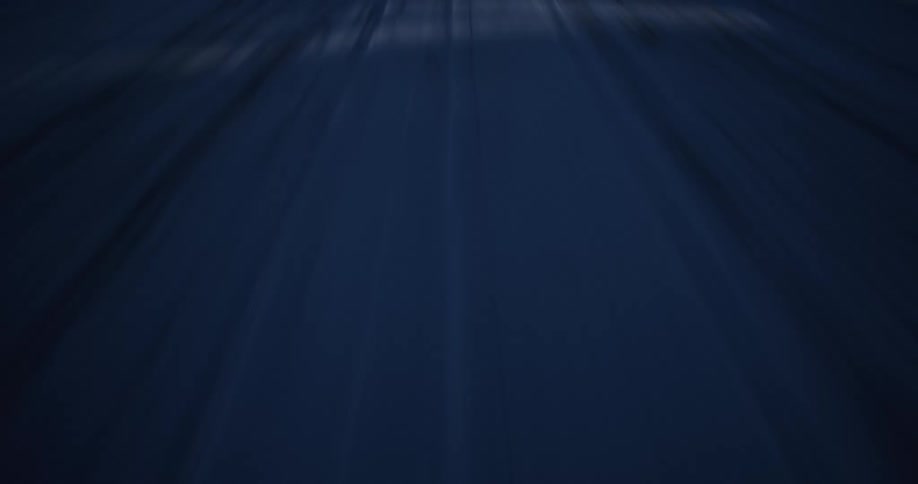 High-speed motion blur creates a dark and dynamic abstract background with streaks of light