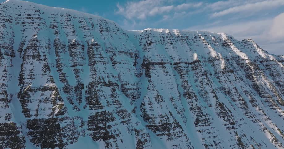 A breathtaking timelapse reveals shadows moving across the face of a majestic, snow-covered mountain