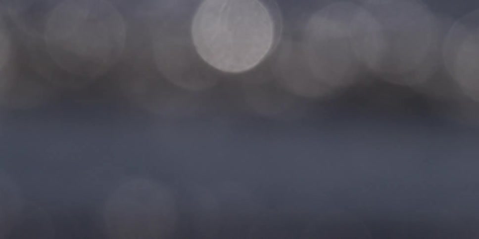 Soft, shimmering out-of-focus lights create a calm and abstract bokeh background