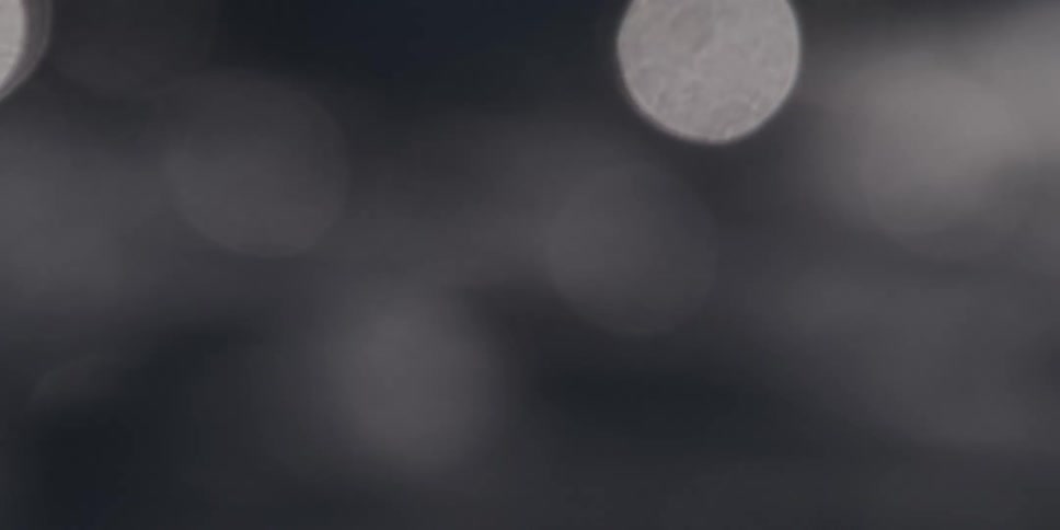 Dreamy abstract bokeh lights shimmer and drift in a mesmerizing black and white display