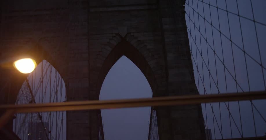 Vehicle crosses the bridge over the river at night