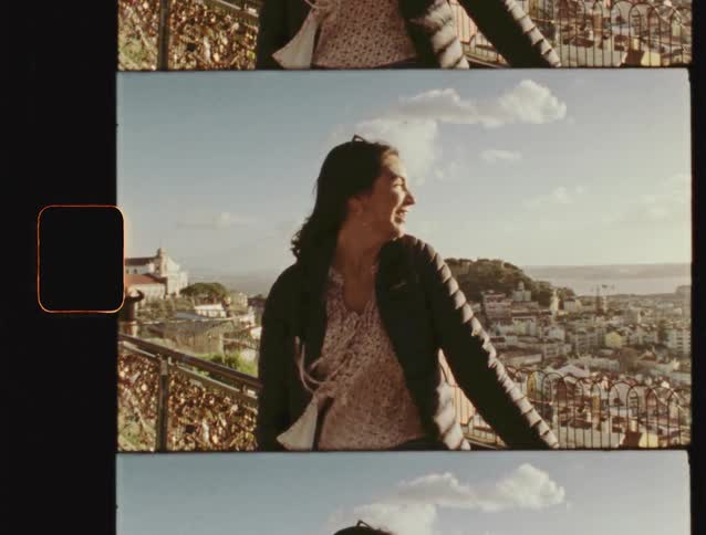 A smiling woman waves to the camera in a retro film strip format with a beautiful European city in the background