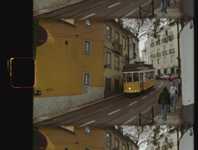 A classic yellow tram glides through the historic streets of Lisbon in this vintage-style split-screen film footage