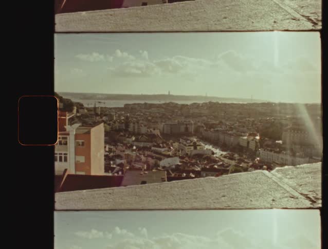 A retro, super 8mm style shot looking out over the beautiful cityscape of Lisbon, Portugal, on a sunny day