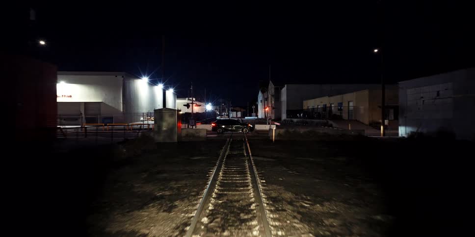 Suspenseful first-person view from a train approaching a railroad crossing at night and crashing into a stalled car
