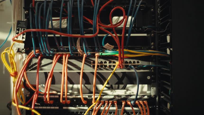 A downward tilt reveals the complex and colorful wiring of an active network server rack