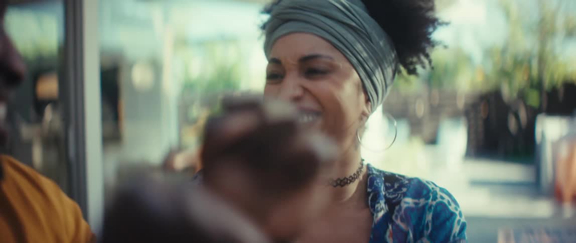 Close-up slow motion shot of a joyful Black man and woman clapping their hands and smiling happily together