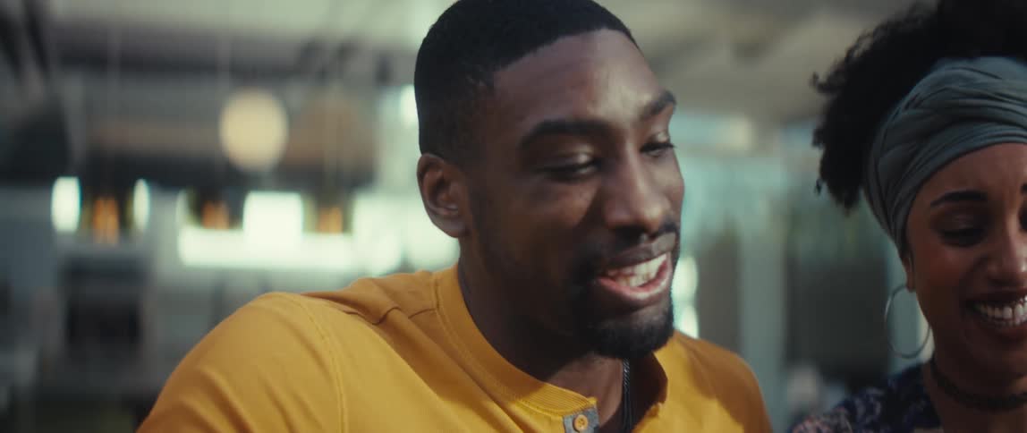 Close-up slow motion shot of an African American man and woman having an animated conversation, using their hands to express themselves