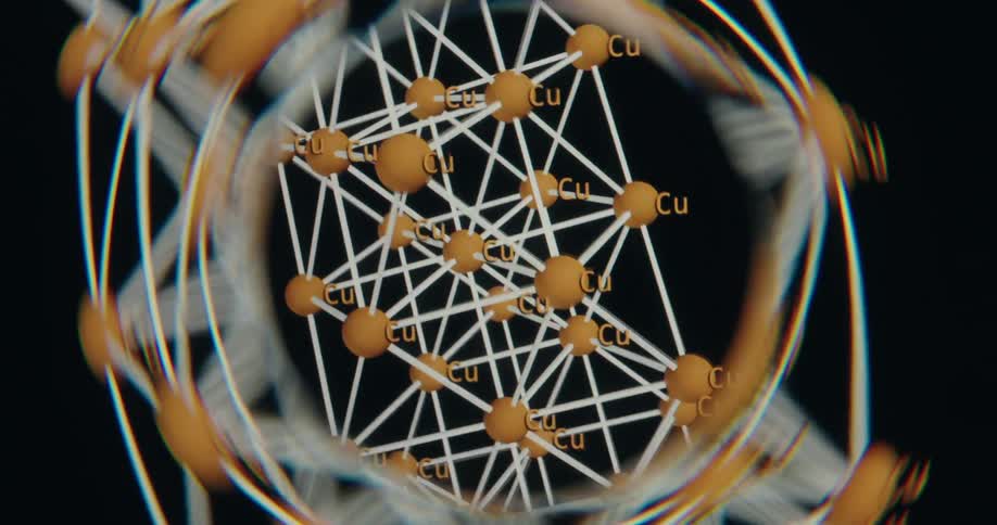 An intricate 3D animation showcases the rotating molecular structure of a copper crystal lattice against a black background