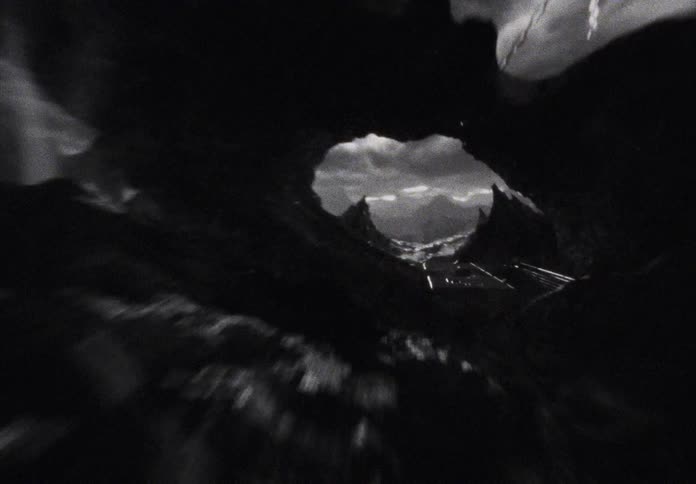 An epic black and white animated sequence hurtles through a dystopian landscape, culminating in the dramatic reveal of a sneaker held by chains