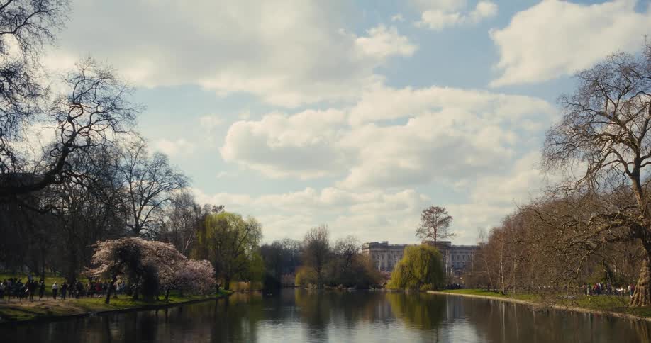 A scenic view across the lake in St. James's Park towards Buckingham Palace on a sunny spring day in London