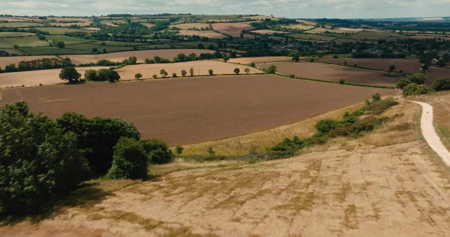 An aerial view reveals the beautiful patchwork of fields and rolling hills of the English countryside