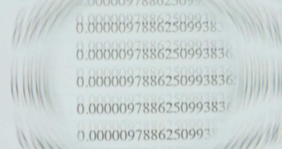 A close-up view through a distorted lens shows endless lines of numerical data scrolling on a computer screen