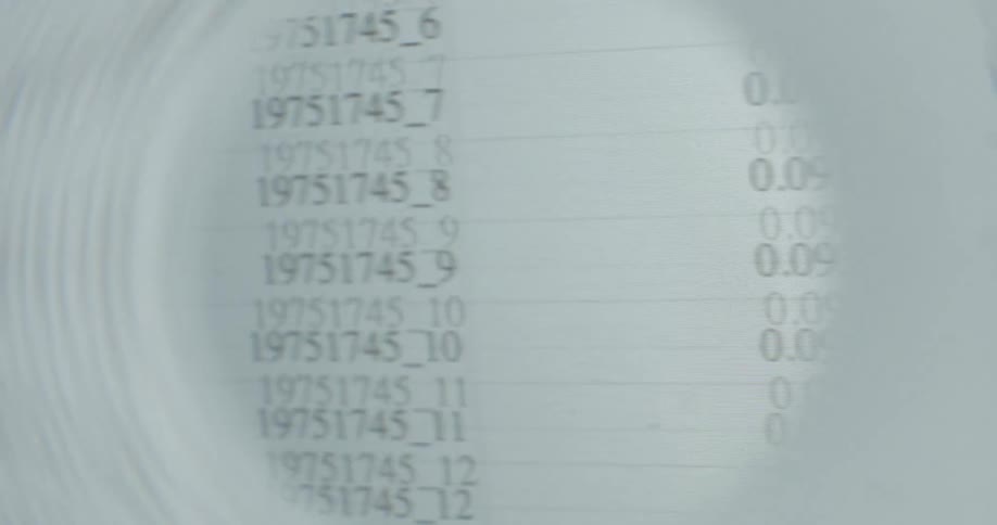 A magnifying glass moves over columns of numerical data on a spreadsheet, representing analysis and inspection