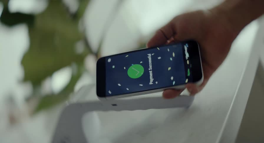 A vortex visual effect reveals a close-up of a successful contactless payment made with a smartphone, showing a confirmation screen with celebratory animations