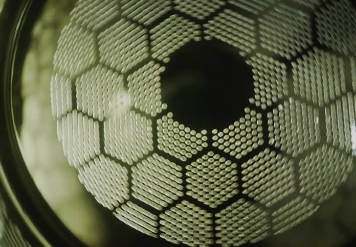 A mesmerizing abstract view of a metallic honeycomb grid with dynamic light creating a futuristic pattern