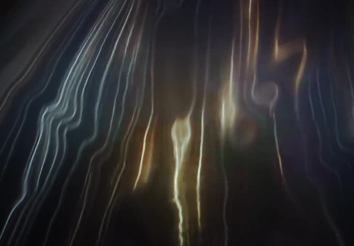 Ethereal golden and white light streaks ripple and wave like liquid silk in a dark, abstract space